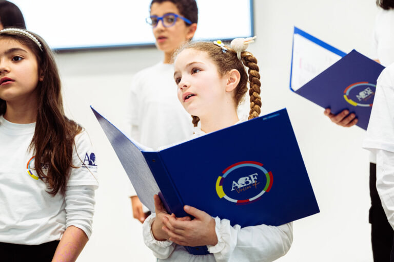 Bambina corista di ABF Voices of Italy che canta durante un concerto